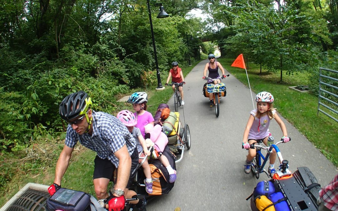 people riding bicycle on road during daytime