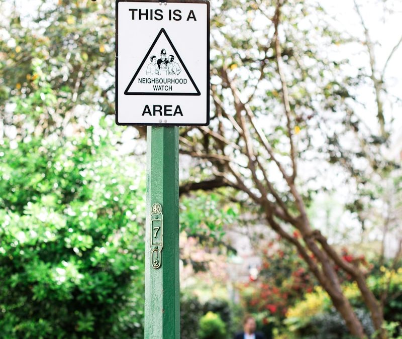 white signage hanging on green road light