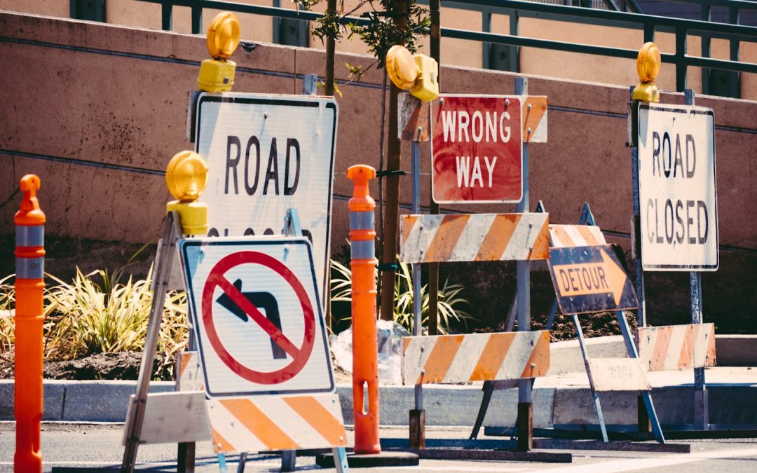 assorted-color signage lot on road during daytime