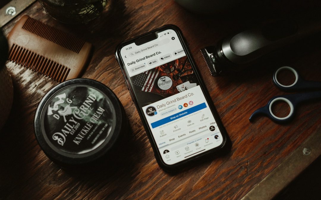 a phone sitting on top of a wooden table next to a comb