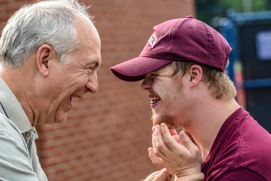 older man mentoring a younger boy