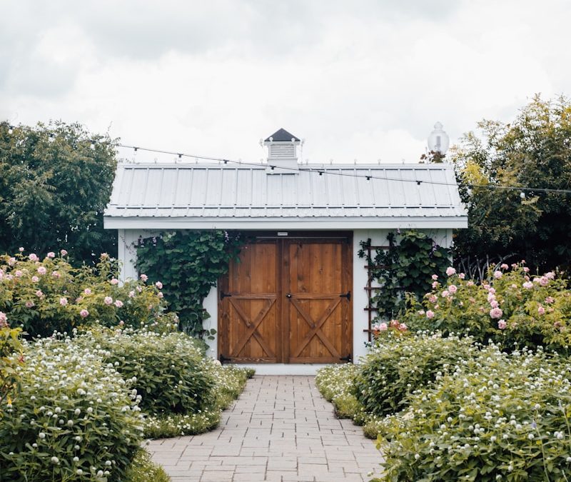 closed brown wooden door under cloudy sky during daytime