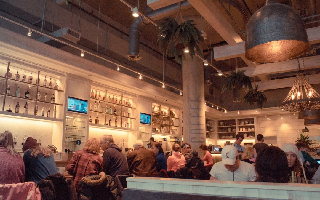 a group of people standing around a bar