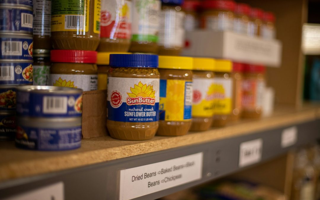 assorted plastic containers on brown wooden shelf